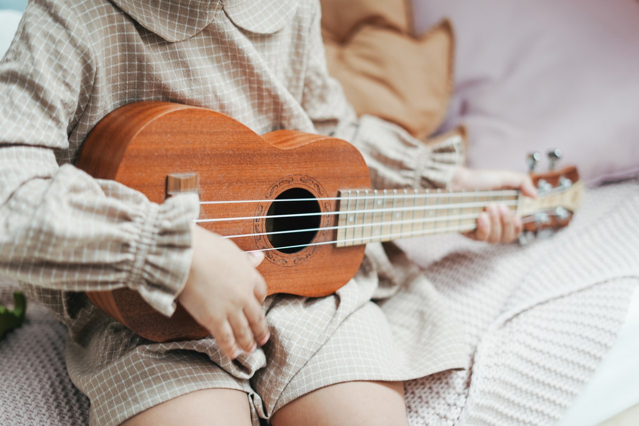 Young girl playing Ukulele