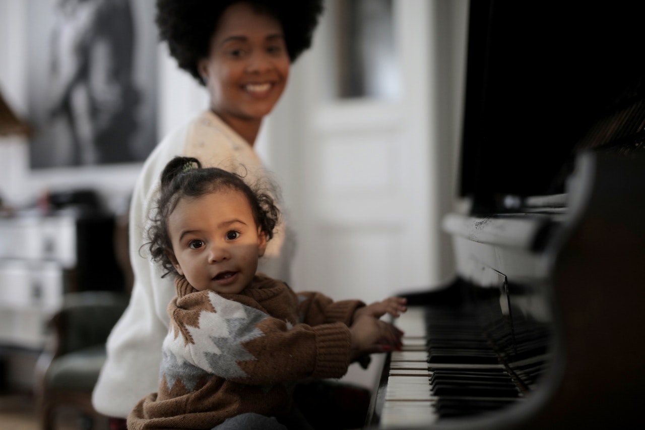 Mommy and baby playing the piano