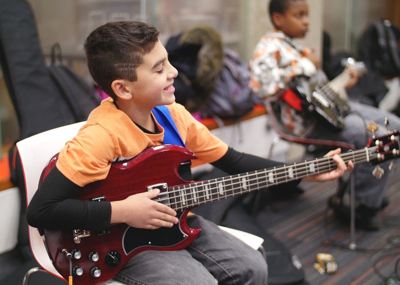 Boy playing bass guitar